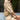 Women's fashion hollow bamboo handbag shoulder bag on a woman wearing a striped beige outfit.
