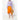 Women's round basket bamboo handbag styled with an orange skirt and lilac sweater.
